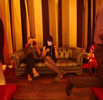 two people sitting on the couch in the lounge