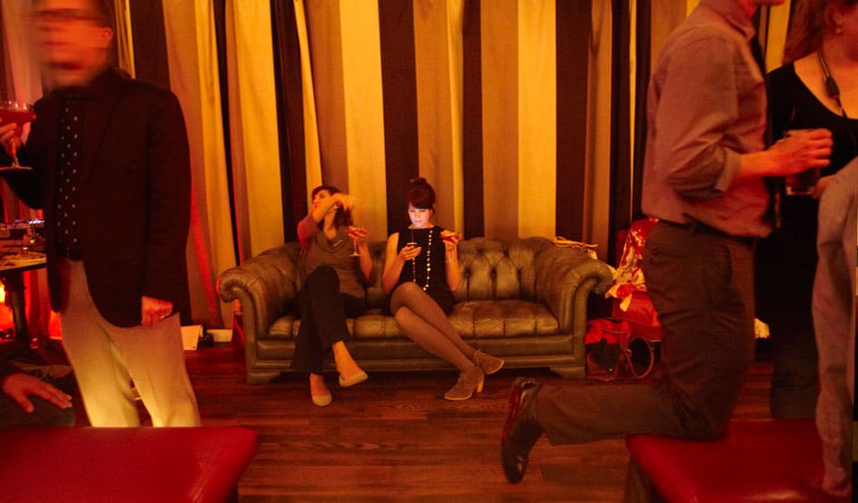 two people sitting on the couch in the lounge